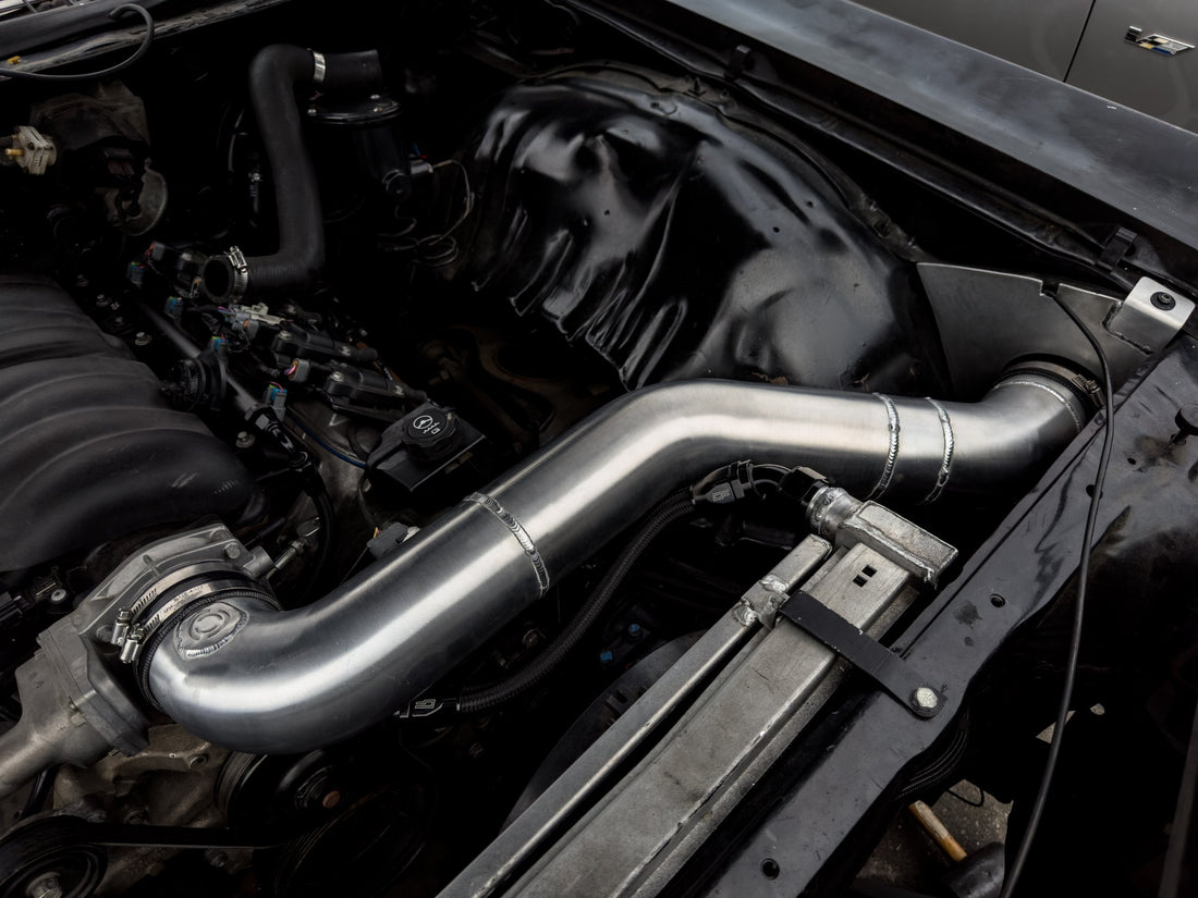 Custom TIG-welded aluminum intercooler piping routed through an engine bay