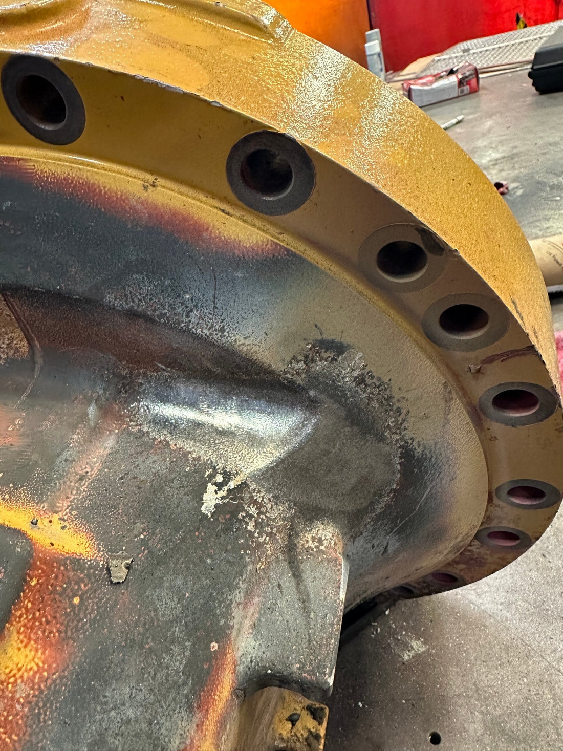 Finished weld repair on a CAT cast housing, blended and peened smooth where the flange meets the housing wall