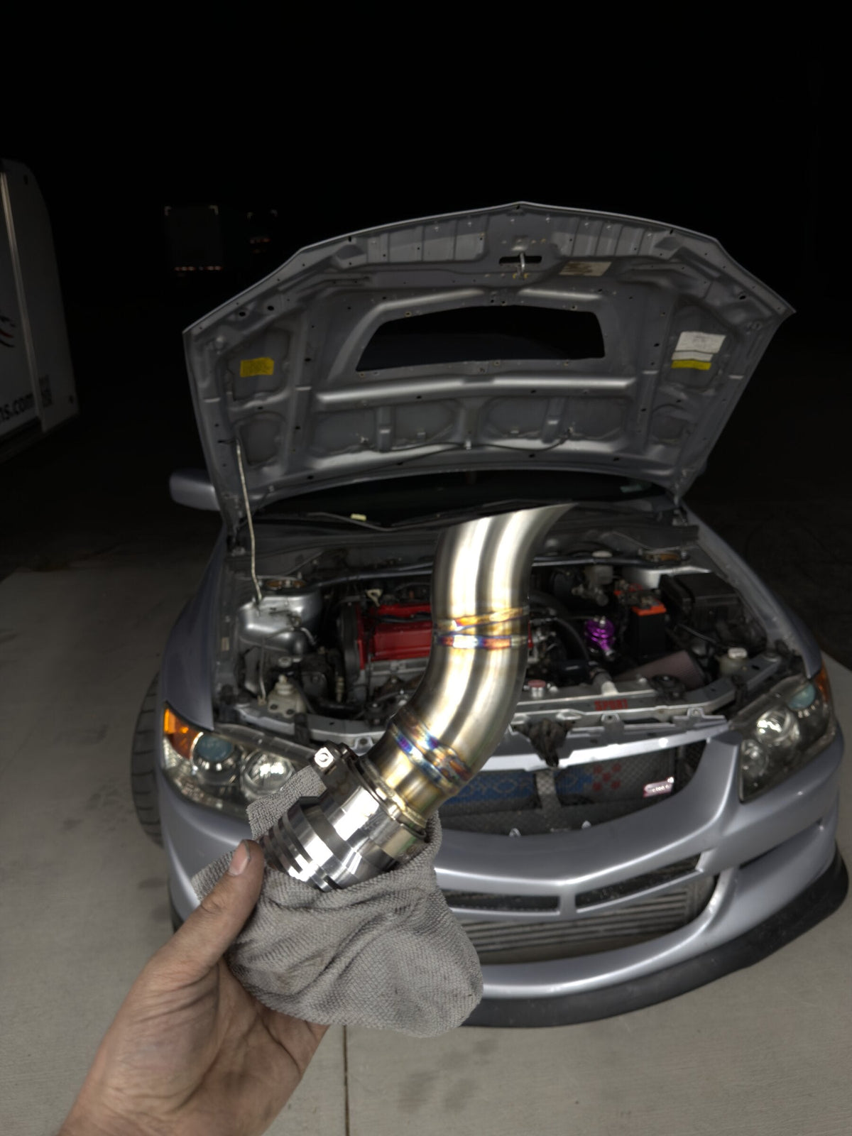 TIG-welded stainless downpipe on a Mitsubishi Evo with heat-tint coloring